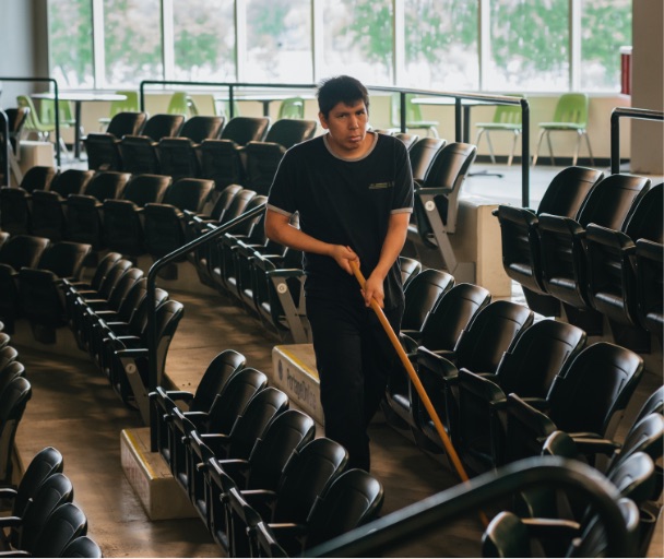 A man cleaning auditorium